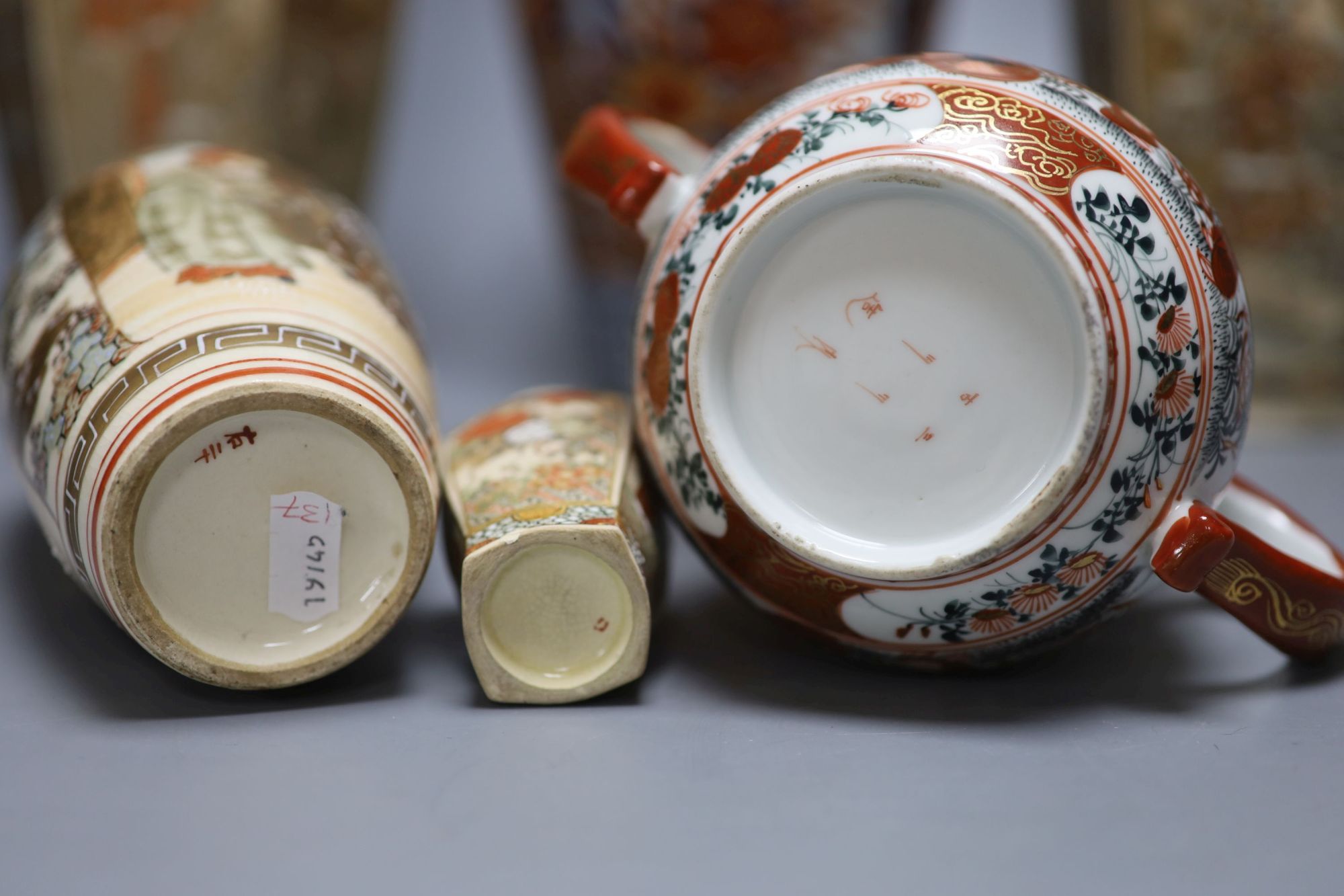 A pair of Japanese Satsuma vases, two others, an Imari vase and a two handled pot, tallest 31cm,